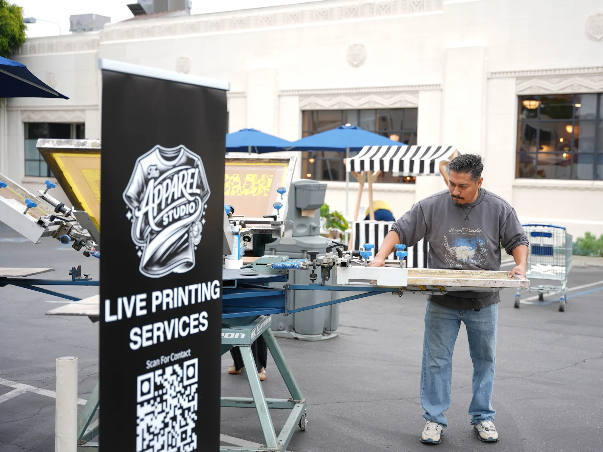 The Apparel Studio team running a live screen printing press at the event